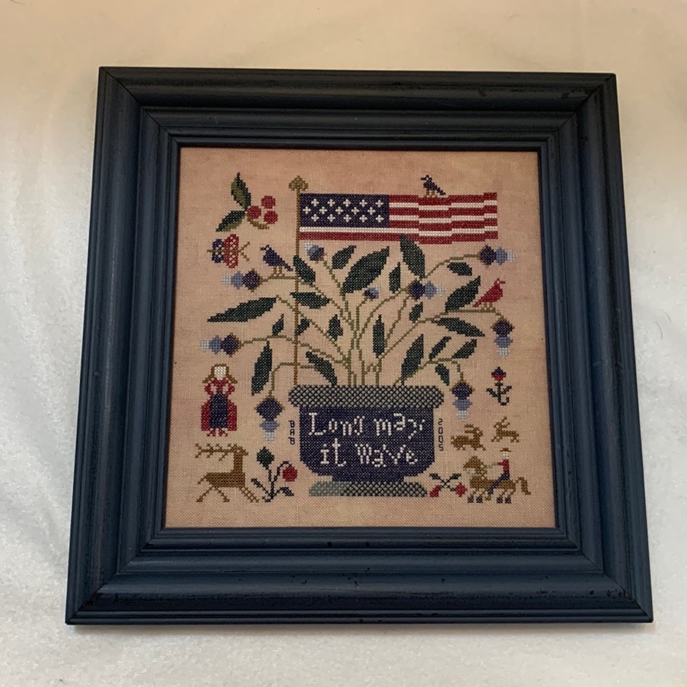 2005 Long May It Wave, cross stitch art that is finished and framed.
